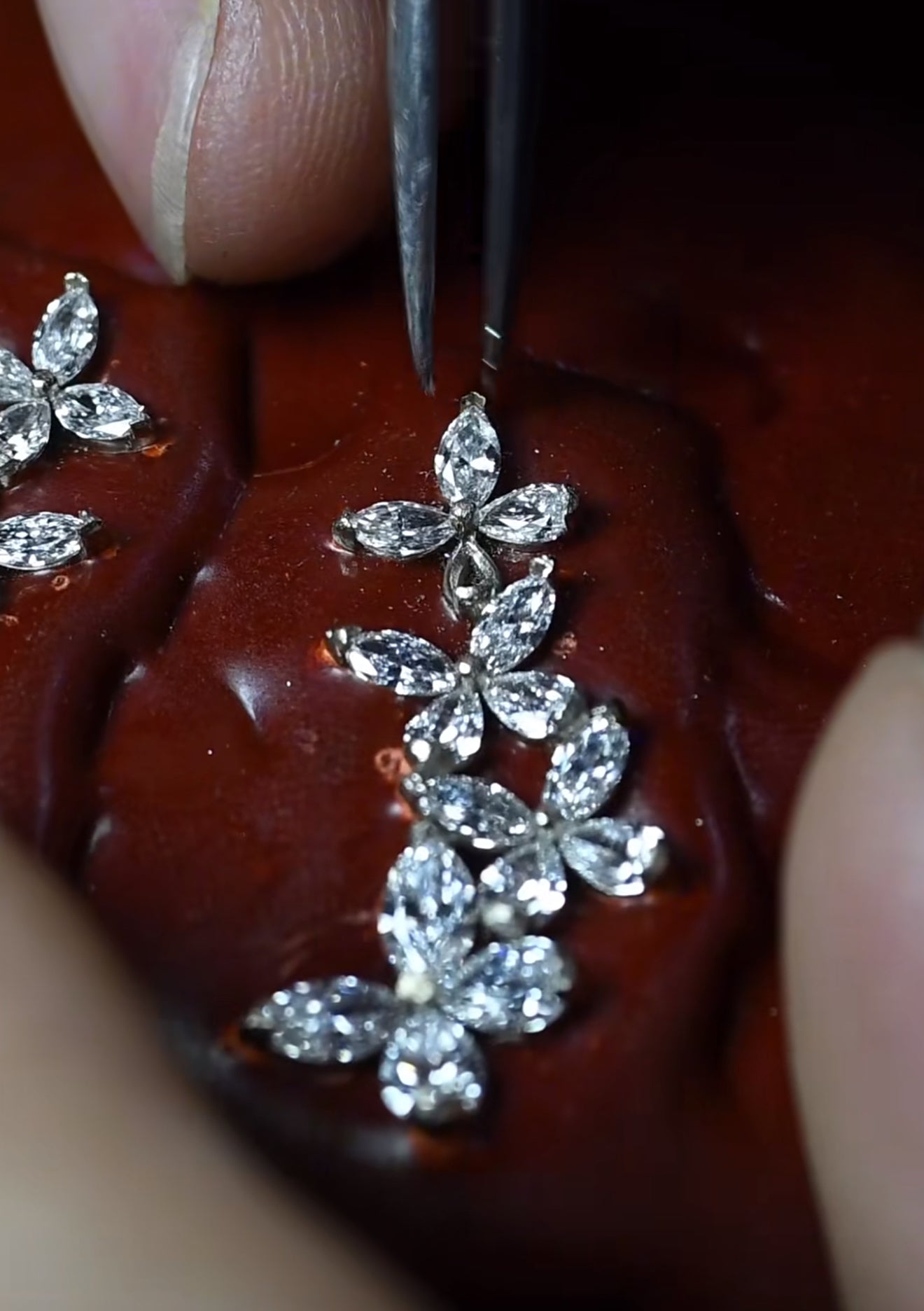 A close-up of stones being set into a Julysnow jewelry piece