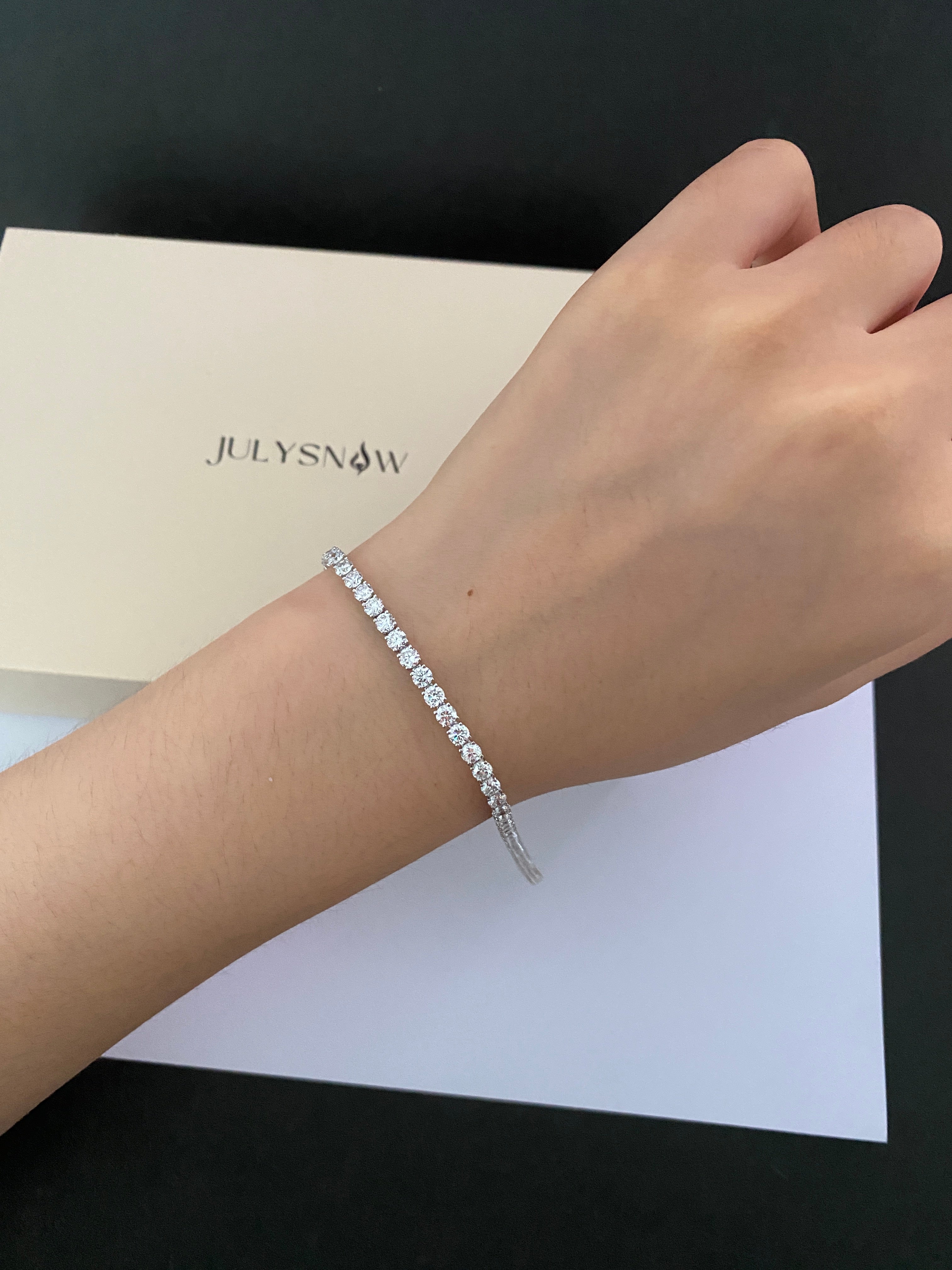 Classic round tennis bracelet worn on the wrist