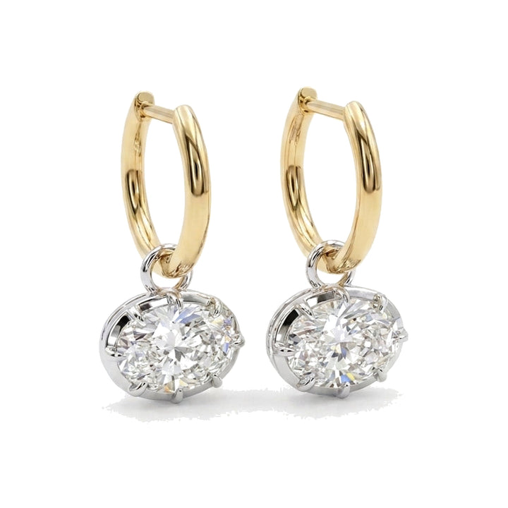 The Infinite oval lab-grown diamond drops suspended from polished yellow gold huggie hoops